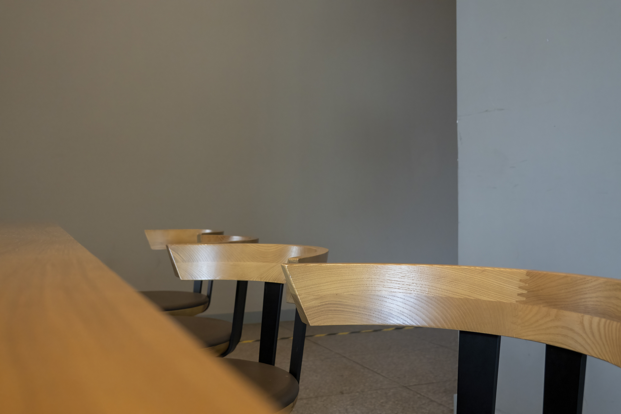 row of chairs in front of a table