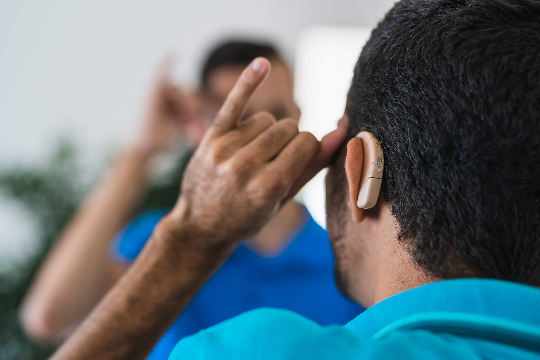 A deaf man with his back turned
