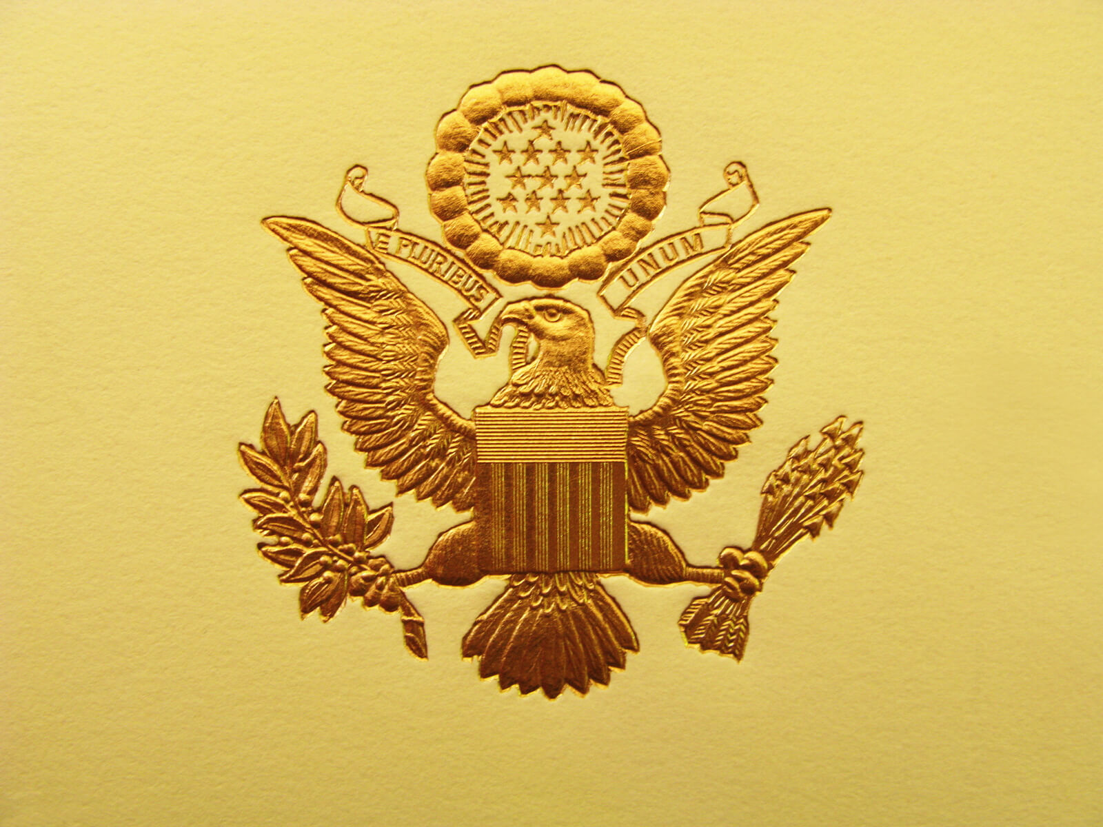 The Seal of the President of the United States is used to mark correspondence from the U.S. president to the United States Congress, and is also used as a symbol of the presidency. The central design, based on the Great Seal of the United States, is the official coat of arms of the U.S. presidency and also appears on the presidential flag. The stripes on the shield represent the 13 original states, unified under and supporting the chief. The motto (meaning "Out of many, one") alludes to the same concept.