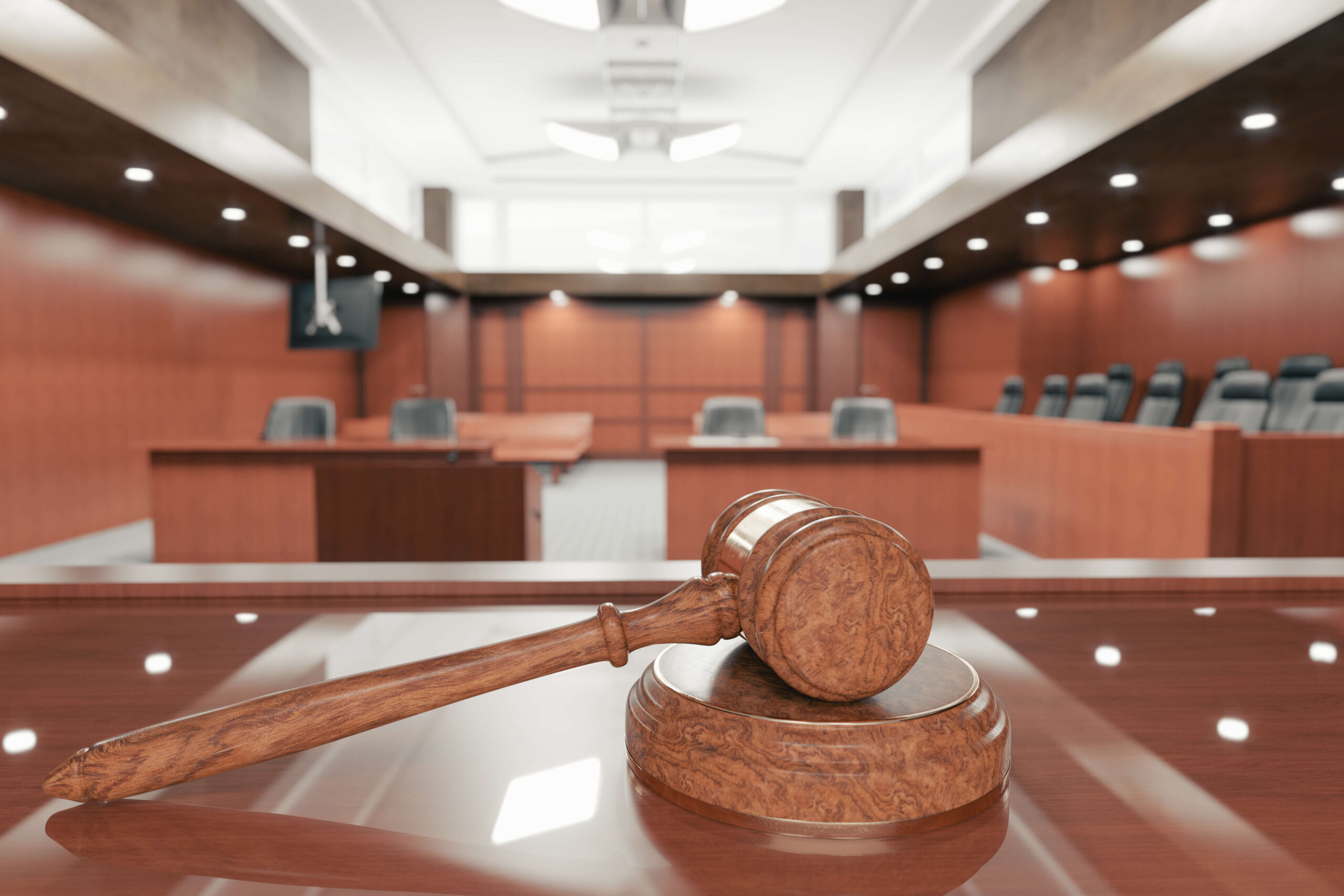 Gavel laying down in courtroom setting.